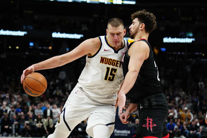 Nuggets center Nikola Jokic (15) drives at Houston Rockets center Alperen Sengun (28) in the second half at Ball Arena.